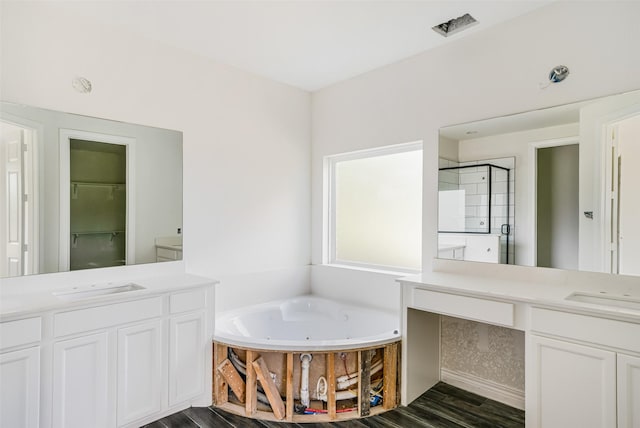 16518 Boston Post Rd, Cypress, TX 77429 - bathroom with vanity, a whirlpool tub, a stall shower, and wood finished floors