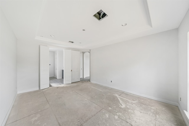 unfurnished bedroom featuring a tray ceiling