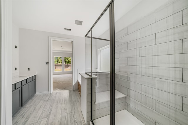 bathroom featuring an enclosed shower and vanity