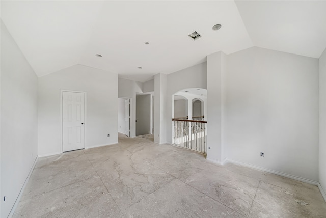 unfurnished room with vaulted ceiling