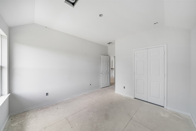 unfurnished bedroom with a closet and vaulted ceiling