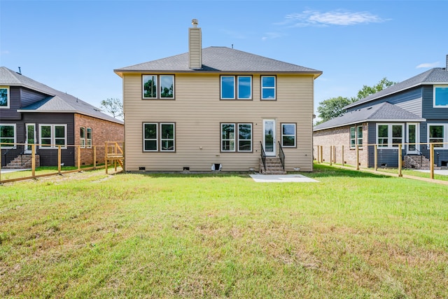 rear view of property featuring a yard