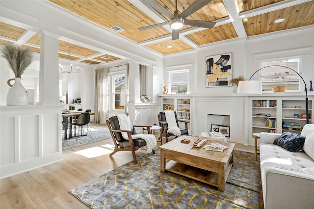 506 E Evergreen St, San Antonio, TX 78212 - living room featuring a brick fireplace, a wood ceiling with exposed beams, a chandelier, wood finished floors, and crown molding