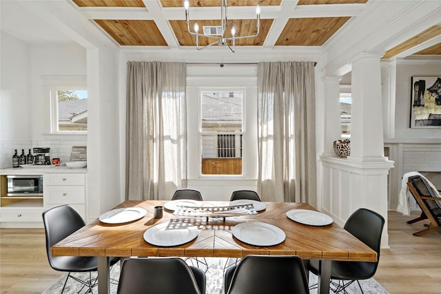 506 E Evergreen St, San Antonio, TX 78212 - dining area featuring coffered ceiling, a chandelier, light wood-type flooring, ornate columns, and crown molding