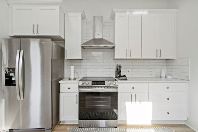 506 E Evergreen St, San Antonio, TX 78212 - kitchen featuring stainless steel appliances, wall chimney exhaust hood, light countertops, and decorative backsplash