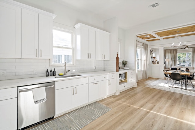506 E Evergreen St, San Antonio, TX 78212 - kitchen featuring stainless steel dishwasher, white cabinets, tasteful backsplash, light wood-style floors, and coffered ceiling
