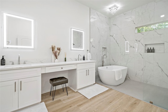 506 E Evergreen St, San Antonio, TX 78212 - bathroom with double vanity, wood finished floors, a soaking tub, and a marble finish shower