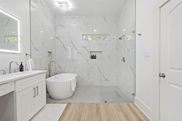506 E Evergreen St, San Antonio, TX 78212 - full bathroom featuring vanity, a soaking tub, wood finished floors, and a marble finish shower