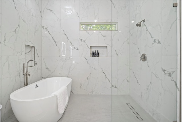 506 E Evergreen St, San Antonio, TX 78212 - bathroom with a soaking tub, a marble finish shower, and tile walls