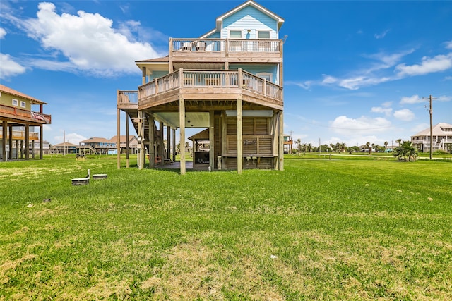 rear view of property featuring a yard and a deck