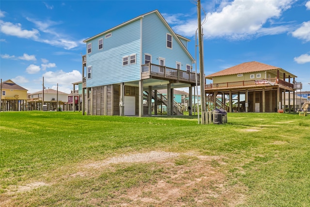 rear view of property featuring a lawn