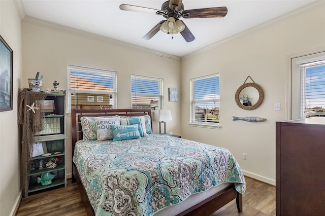 bedroom with ceiling fan, dark hardwood / wood-style floors, and crown molding