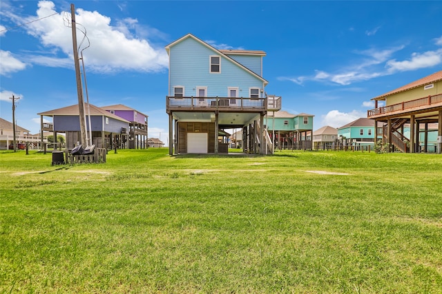 back of property with a lawn and a garage