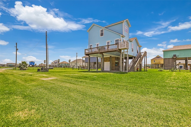 rear view of house featuring a deck and a lawn