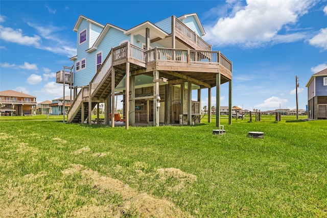 rear view of house with a deck and a lawn