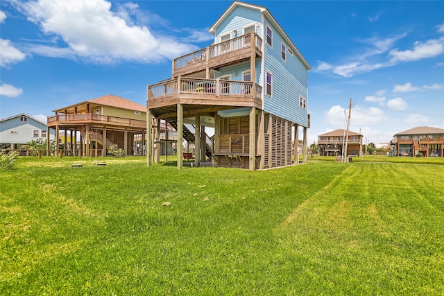 rear view of house with a wooden deck and a yard