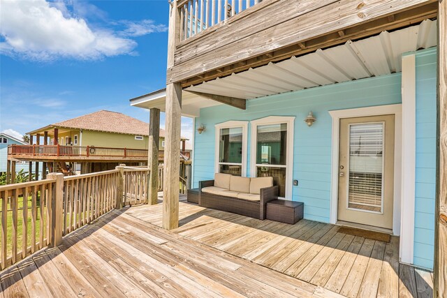 wooden terrace featuring an outdoor living space