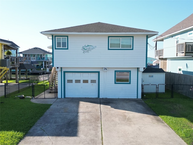 front facade with a balcony, cooling unit, a garage, and a front lawn