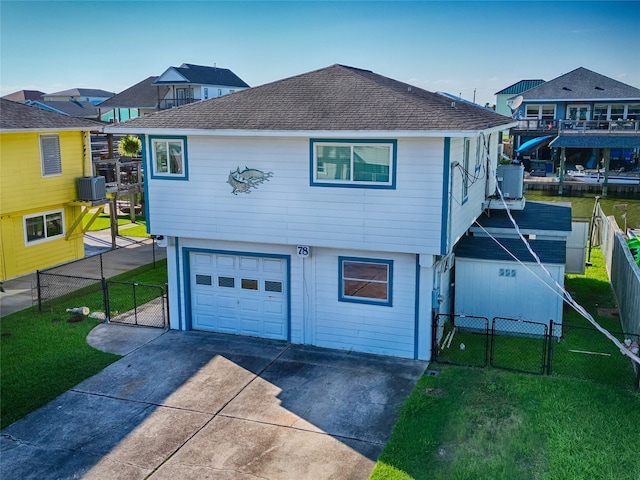 view of front of property with a garage, central air condition unit, and a front lawn