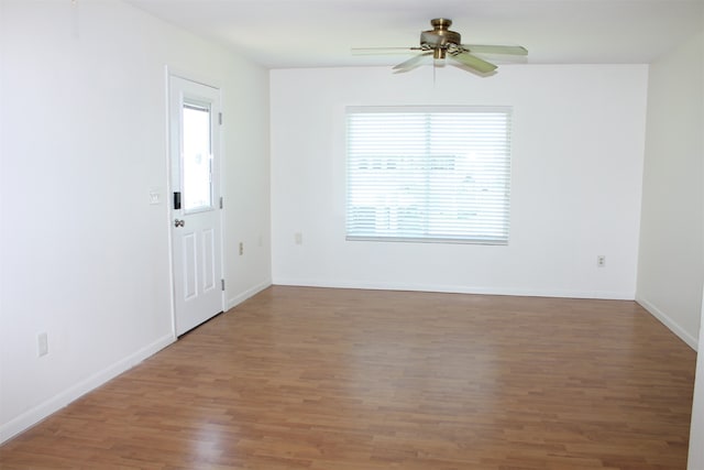 spare room featuring wood-type flooring and ceiling fan