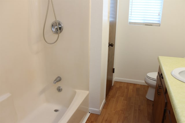 full bathroom with shower / bathing tub combination, wood-type flooring, vanity, and toilet