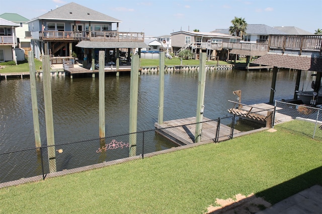 dock area with a lawn and a water view