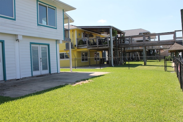 view of yard with a patio, a balcony, and central air condition unit