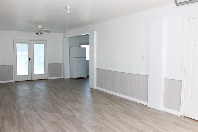 interior space with french doors, light wood-type flooring, ceiling fan, and a healthy amount of sunlight