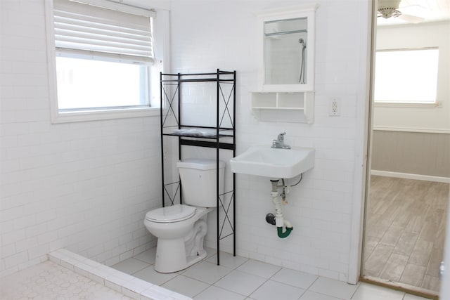 bathroom with sink, a shower, hardwood / wood-style floors, and toilet