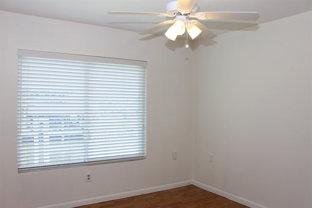 unfurnished room with ceiling fan, dark hardwood / wood-style flooring, and a wealth of natural light