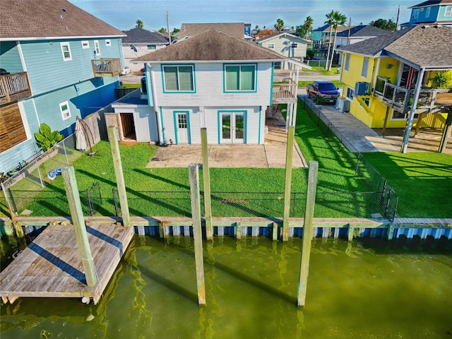 exterior space featuring a yard, a water view, and a patio area