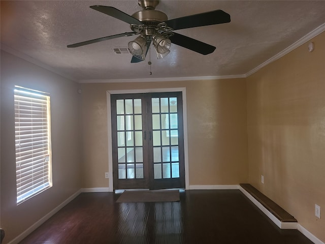 unfurnished room featuring french doors, dark hardwood / wood-style floors, crown molding, a textured ceiling, and ceiling fan