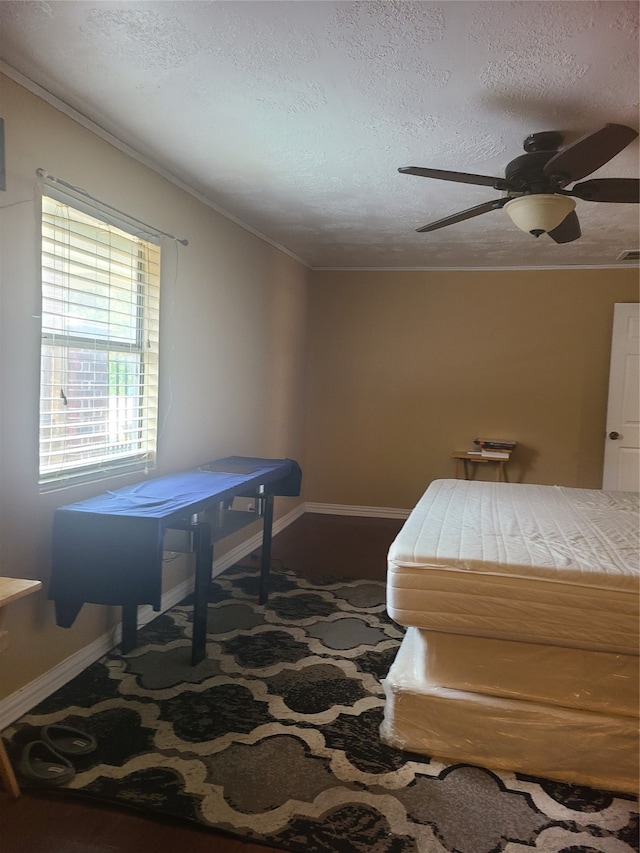 bedroom with a textured ceiling and ceiling fan