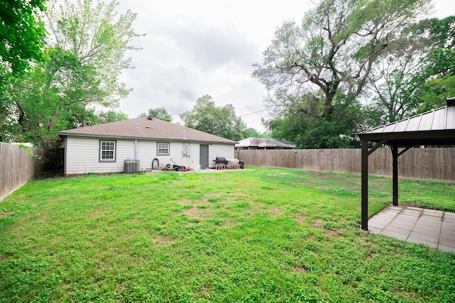 view of yard featuring a gazebo and central AC