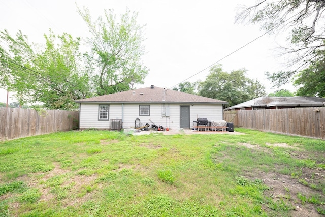 rear view of property with a patio, a yard, and cooling unit