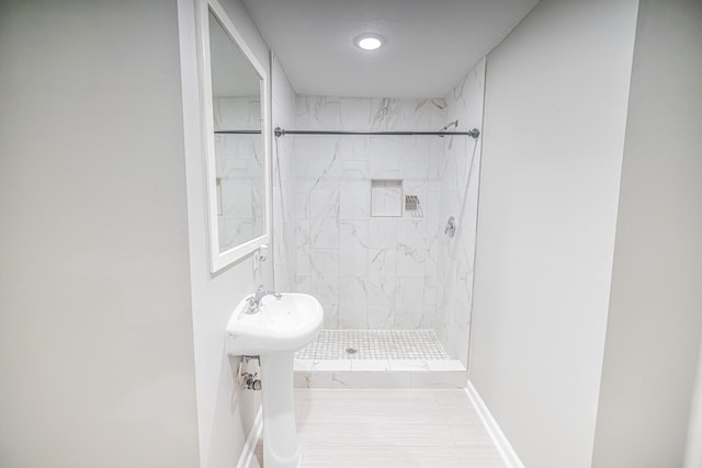 bathroom featuring tile patterned floors and a tile shower