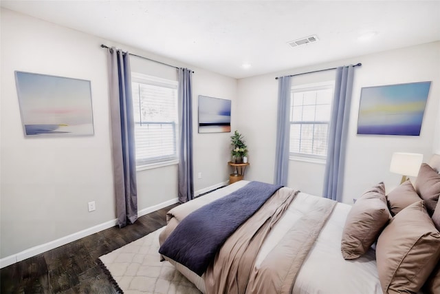 bedroom with dark wood-type flooring