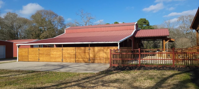 exterior space featuring a lawn and an outbuilding