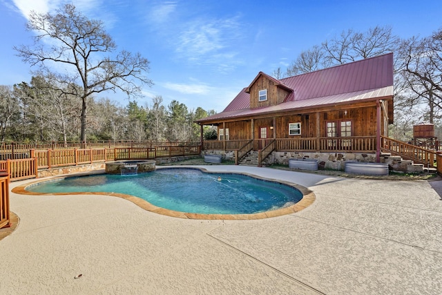 view of swimming pool featuring a patio area and an in ground hot tub