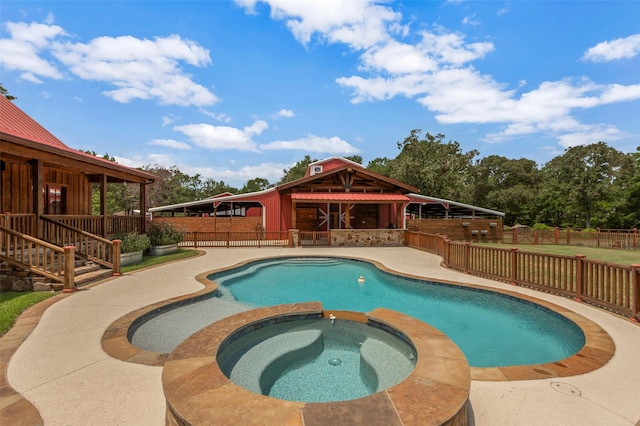 view of swimming pool featuring a patio and an in ground hot tub