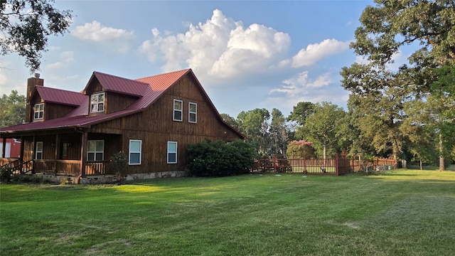 view of home's exterior featuring a yard and covered porch