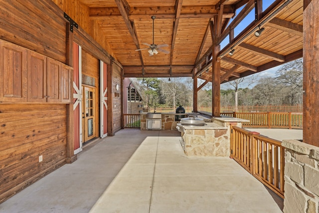 view of patio with ceiling fan and area for grilling