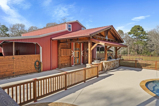 view of patio featuring an outbuilding