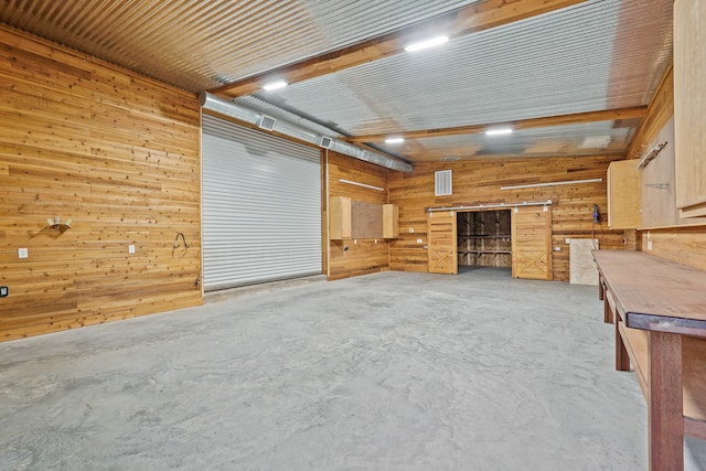 unfurnished living room featuring wood ceiling and wood walls