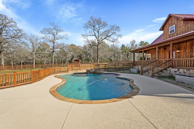 view of swimming pool featuring an in ground hot tub and a patio area