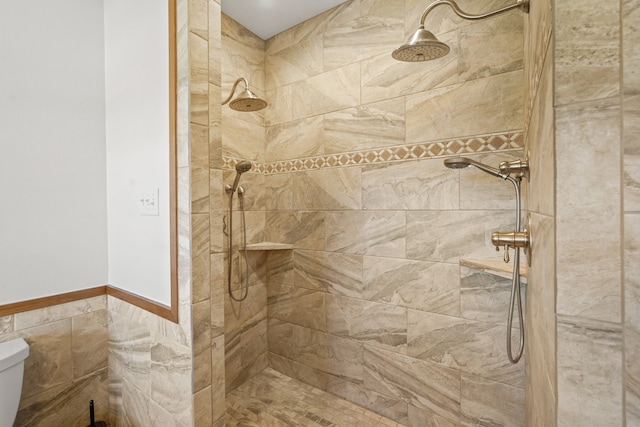 bathroom featuring a tile shower, tile walls, and toilet