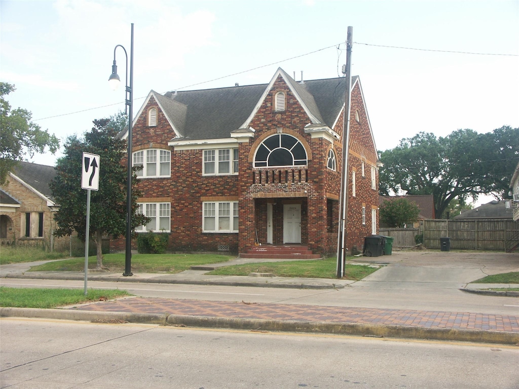 traditional home with brick siding and fence