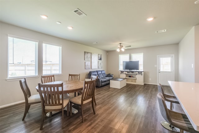 dining area featuring ceiling fan, dark wood-type flooring, and a healthy amount of sunlight