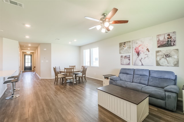 living room featuring ceiling fan and hardwood / wood-style floors