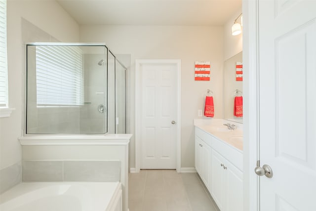 bathroom with shower with separate bathtub, vanity, and tile patterned floors